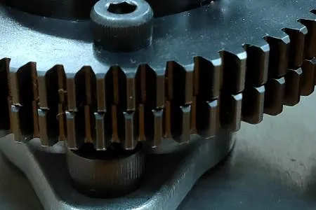 Anti-backlash gear where two gears of the same shape are stacked and slid slightly